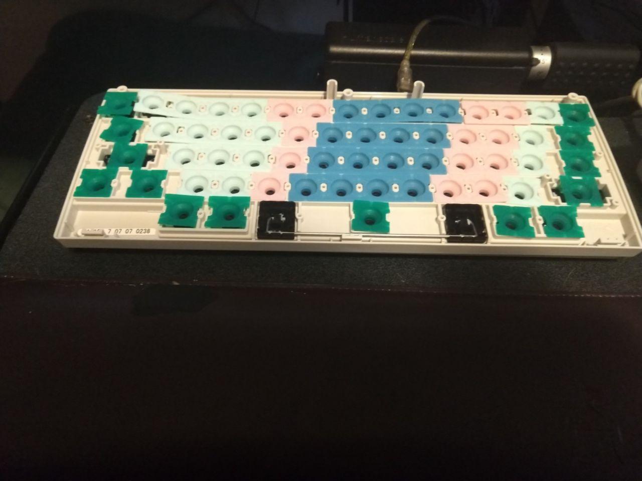Inside of a HHKB Pro 2 with different colored domes installed.