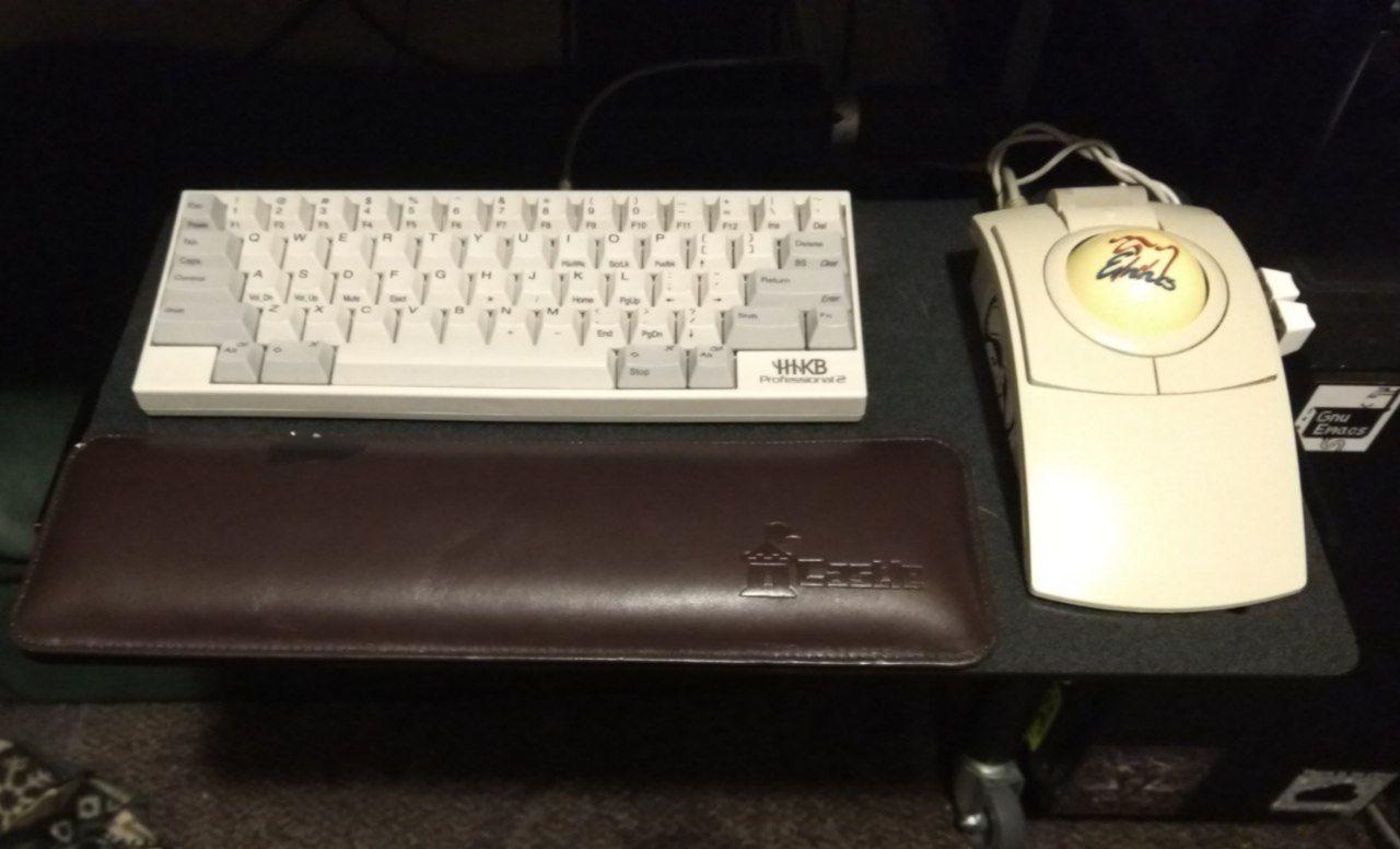 My HHKB on a keyboard tray with my CST trackball.