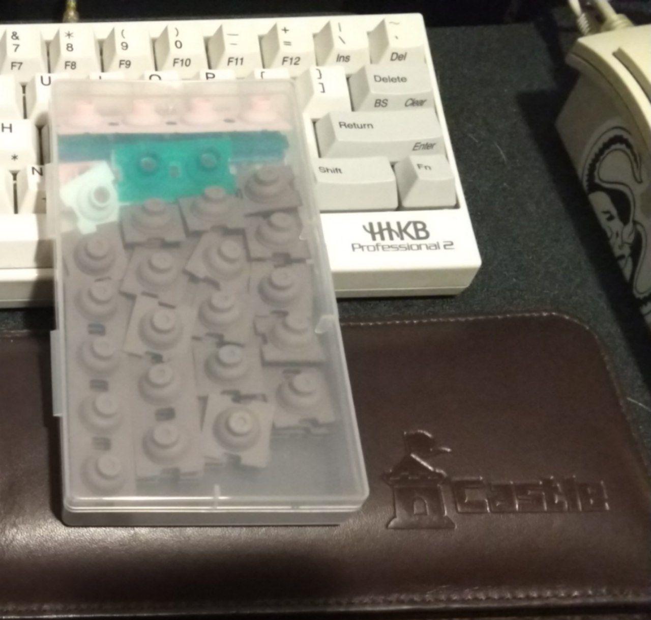 Stock HHKB domes and the extra varied weight domes in a box.